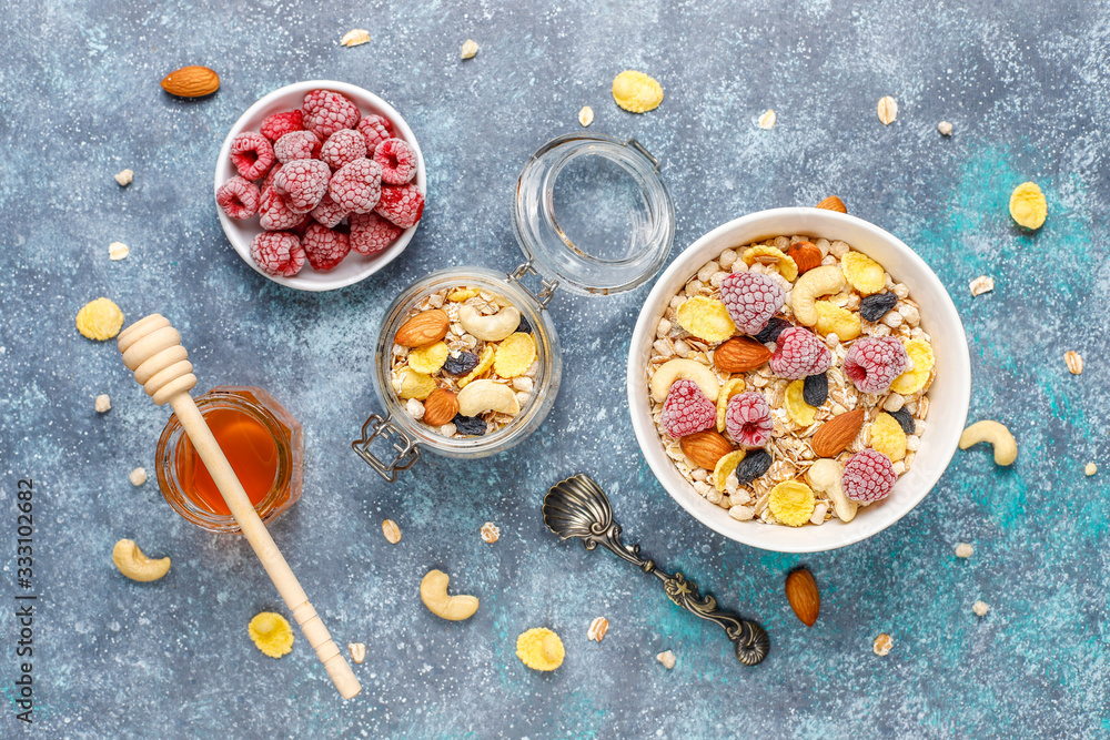 Healthy breakfast. Fresh granola, muesli with nuts and frozen berries. Top view. Copy space.