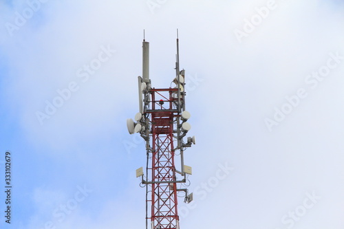 Base station mobile network antenna on a steel structure mast with a repeater.