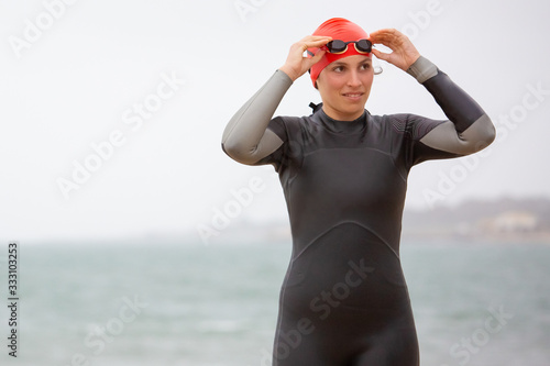 Slika na platnu Young woman in wetsuit wearing goggles