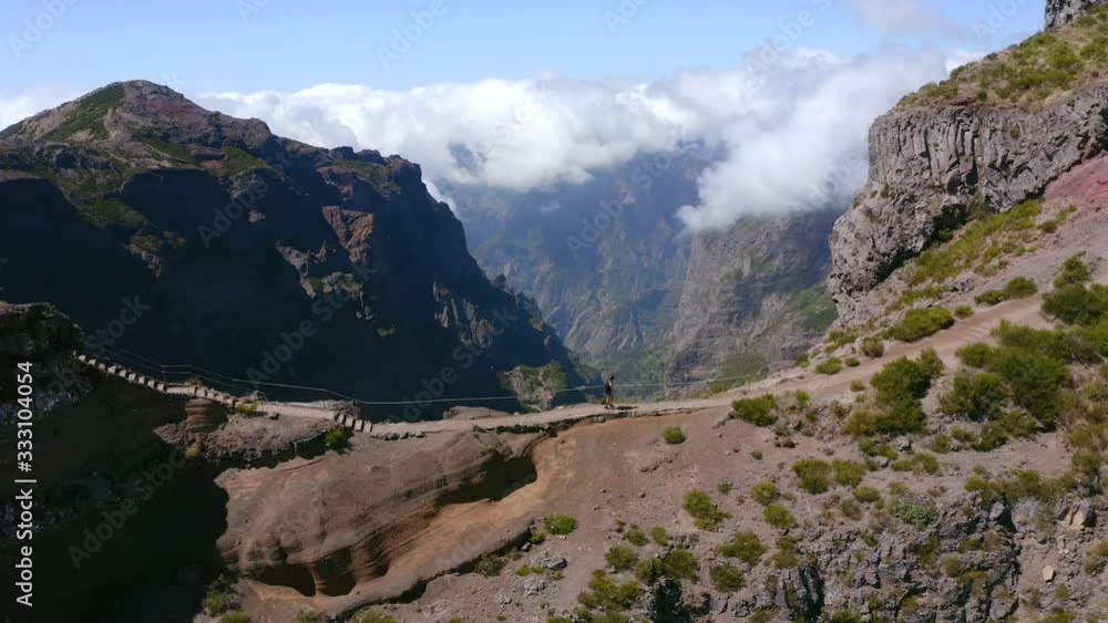 AERIAL: Person walking in Mountains above the clouds in Madeira AERIAL: Person walking in Mountains above the clouds in Madeira
