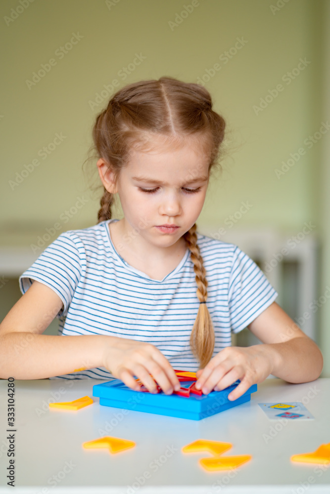 close up. little girl solve mathematical puzzle.