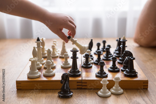 Dad and Son playing chess together at home