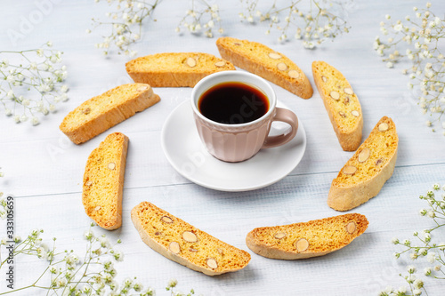 Italian tuscan traditional cookies cantuccini with almonds ,a cup of coffee on light background,top view