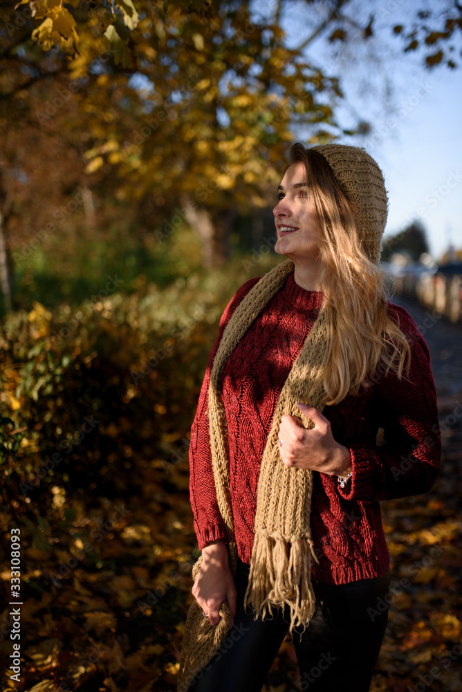 Portrait of a beautiful autumn woman. Girl posing to the camera.