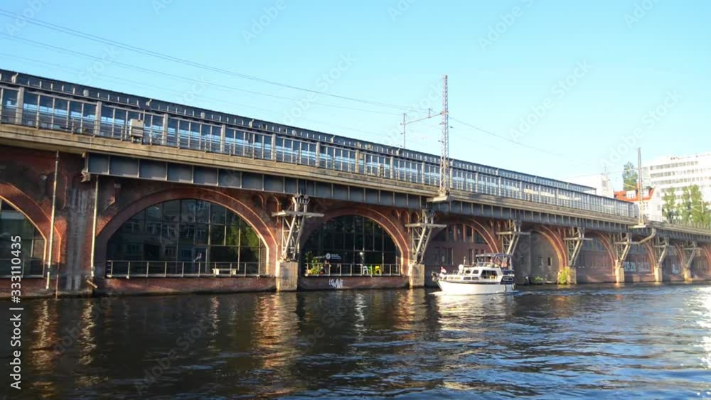 BERLIN - GERMANY, MAY 26, 2017: Bridge in sunset from pleasure boat view on Spree river BERLIN - GERMANY, MAY 26, 2017: Bridge in sunset from pleasure boat view on Spree river