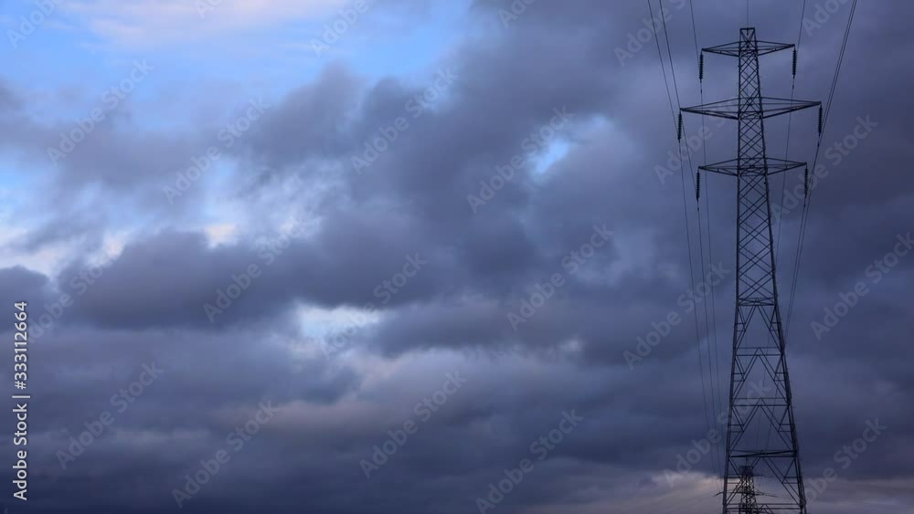 Time lapse of clouds moving over pylon UK 4K