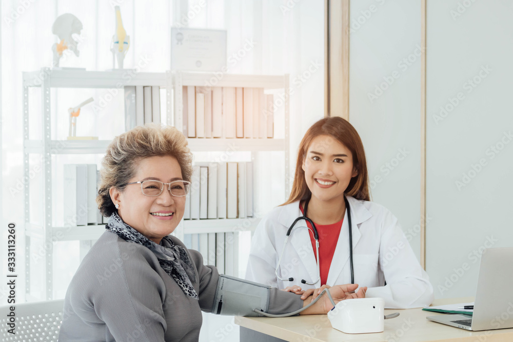 Asian doctor working in the office and discussing to the patient about her symptoms, healtcare and hospital concept. Asian doctor working in the office and discussing to the patient about her symptoms, healtcare and hospital concept.