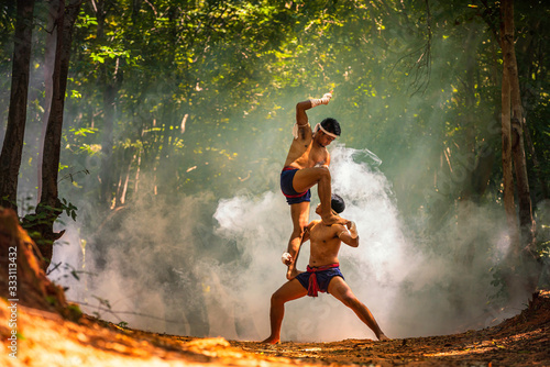 Wai Kru, boxing music. Boxing Fighting with elephants is the background. Krapho, Tha Tum District, Surin, Thailand. photo