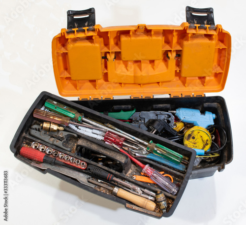 a plastic toolbox full of dirty, dusty, used tools