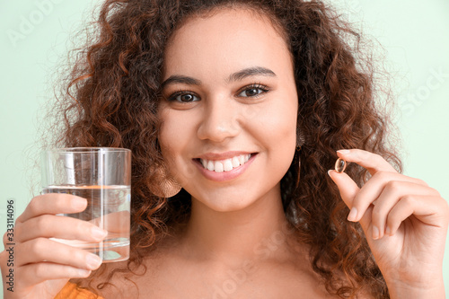 Young woman with fish oil a...