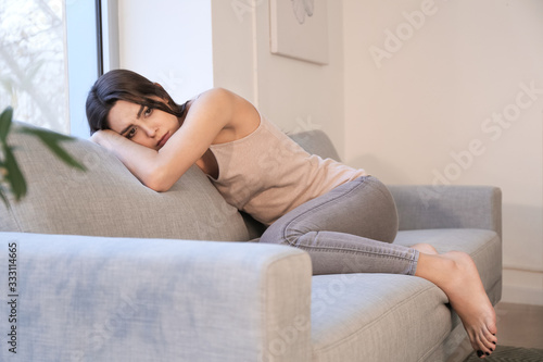 Depressed young woman at home