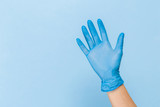 Doctor hand glove shows number five front on blue background.