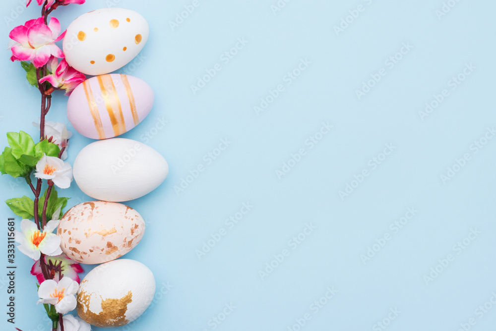 Easter eggs painted in pastel colors on blue background with copy space Easter eggs painted in pastel colors on blue background with copy space