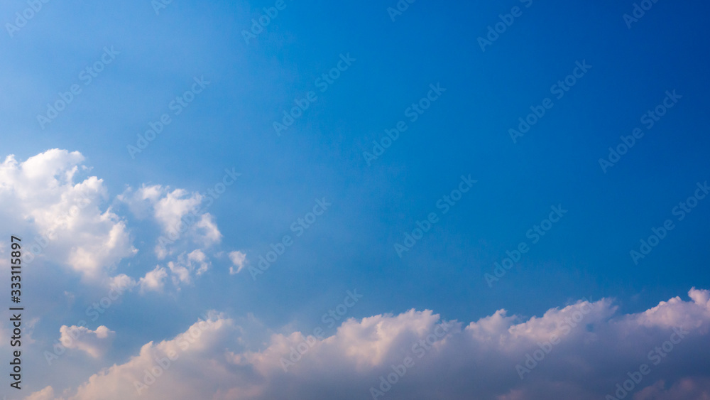 A blue sky with beautiful wisp of cloud for use as a backing or backdrop..