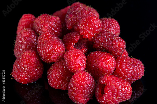 Fresh raspberries close up on a black background