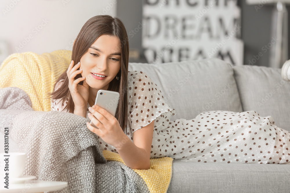Beautiful young woman with mobile phone at home Beautiful young woman with mobile phone at home
