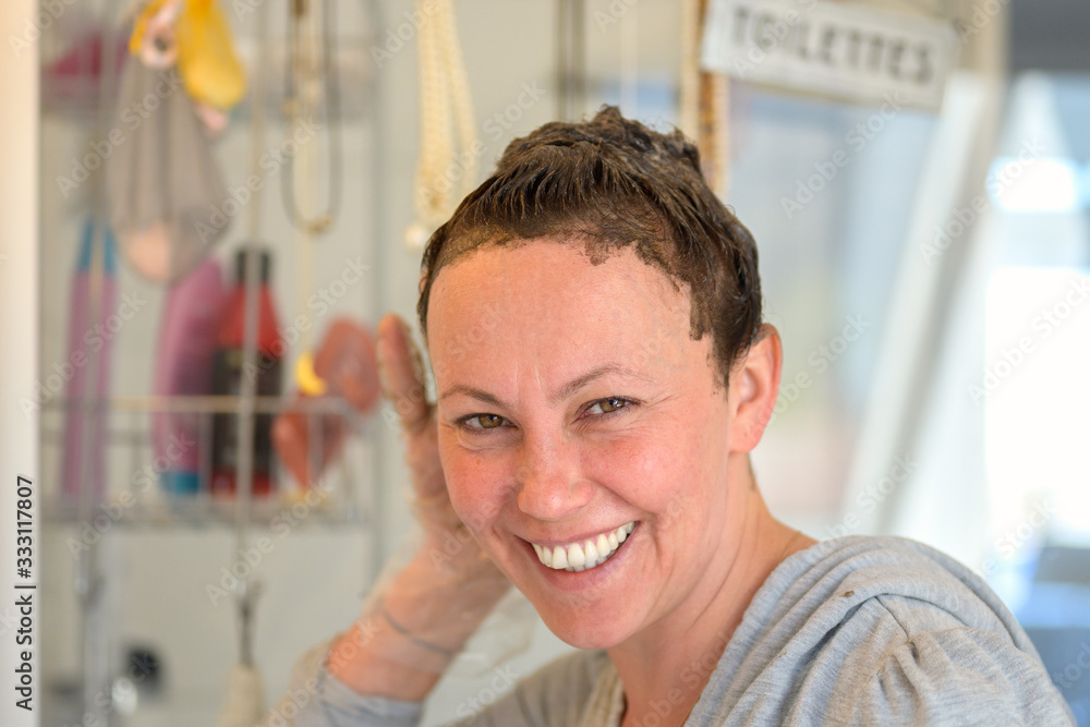 Smiling friendly woman applying hair dye Smiling friendly woman applying hair dye