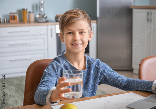 Cute little boy drinking wa...