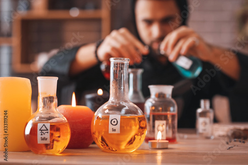 Flasks with potion and cand...