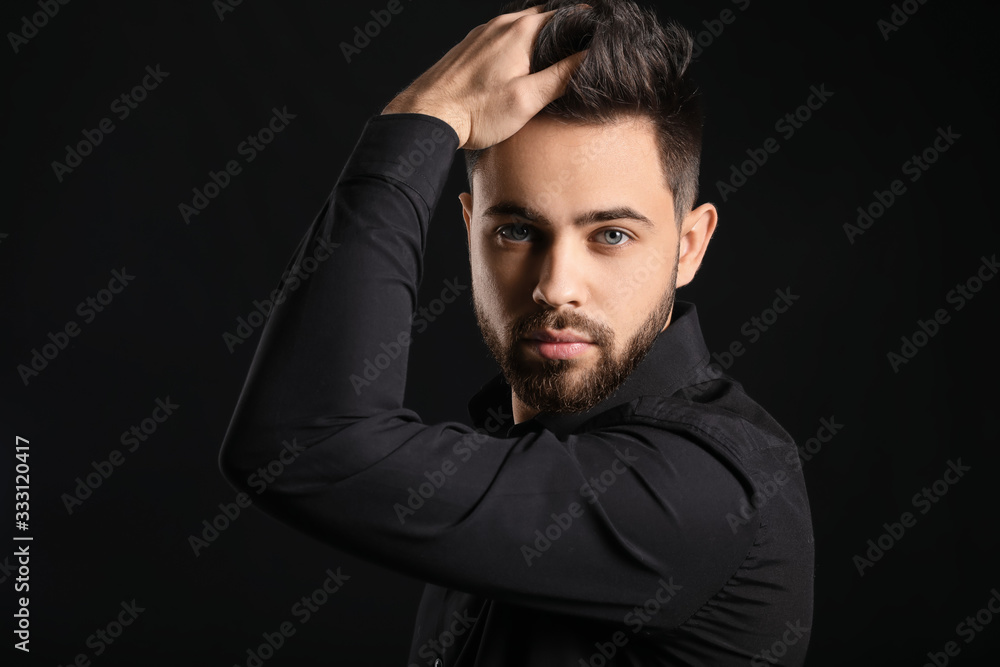 Handsome man with healthy hair on dark background Handsome man with healthy hair on dark background