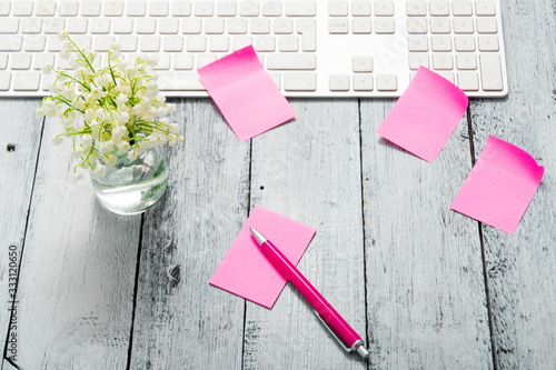 loft style place of work with lily of the valley and pink post its