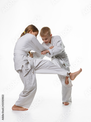 Two judo students try to hook each other up