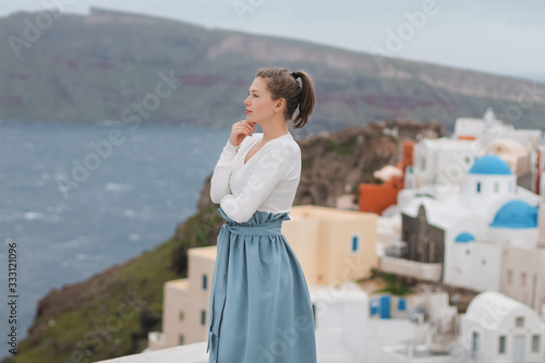 young woman looking at santorini island greece