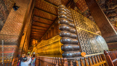 Golden Statue of the Reclining Buddha at Wat Pho Buddhist Temple Complex in the Phra Nakhon District, Bangkok, Thailand. Religious Monument, Tourist Attraction, Travel Destination Concepts.