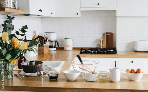 Baking ingredients placed on wooden table, ready for cooking cake.