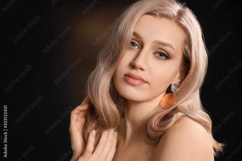 Young blonde with beautiful hair on dark background Young blonde with beautiful hair on dark background