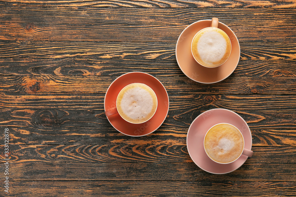 Cups of hot coffee on wooden table Cups of hot coffee on wooden table