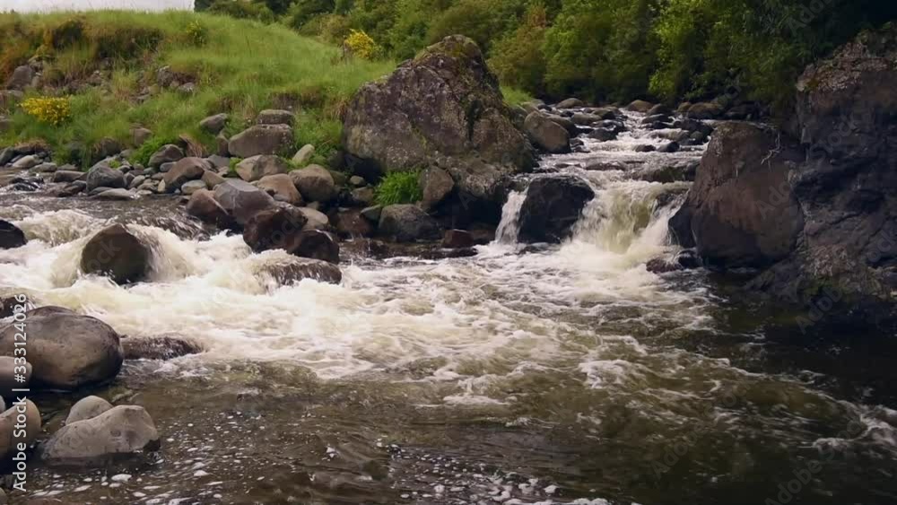 Tumbling, white-water rapids flowing over large rocks in the Waihi River. Waihi Gorge, Canterbury, New Zealand. Tumbling, white-water rapids flowing over large rocks in the Waihi River. Waihi Gorge, Canterbury, New Zealand.