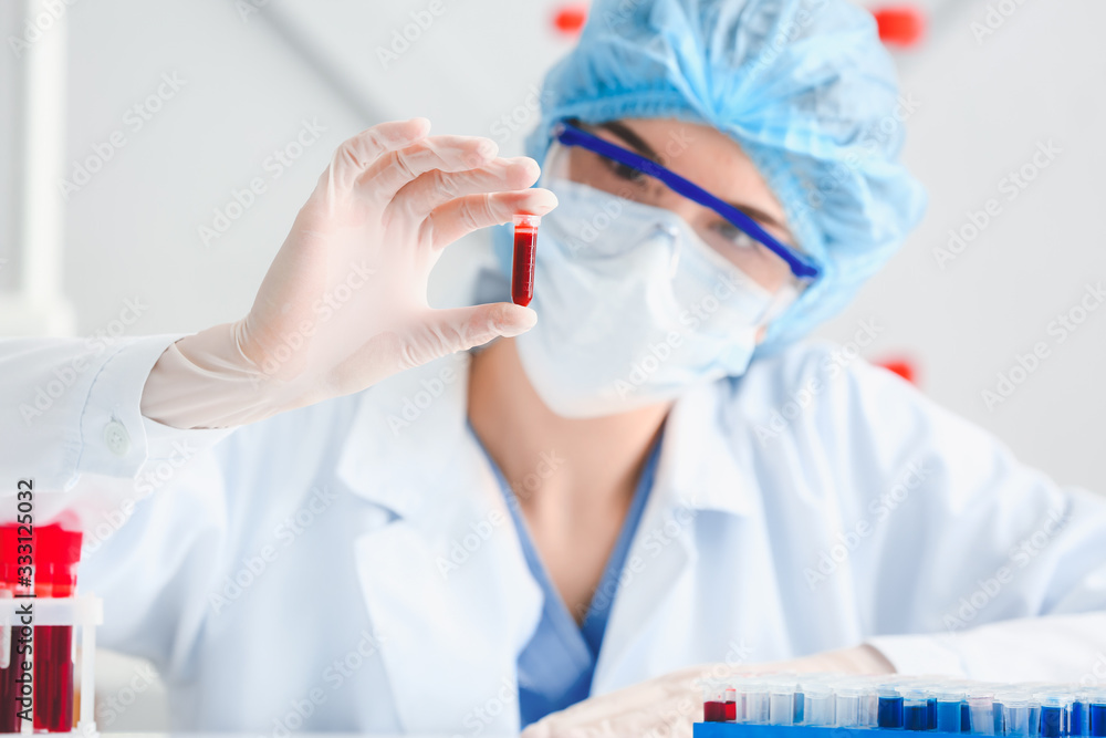 Doctor working with blood samples in laboratory Doctor working with blood samples in laboratory