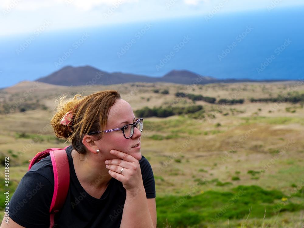 Hiker girl resting. El Hierro is an ideal place for hiking. At the bottom you can see a Canary volcano. Hiker girl resting. El Hierro is an ideal place for hiking. At the bottom you can see a Canary volcano.