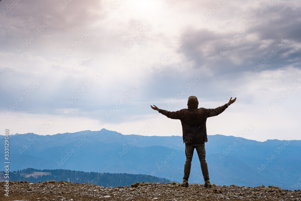 Landscape with silhouette of a standing happy man Landscape with silhouette of a standing happy man