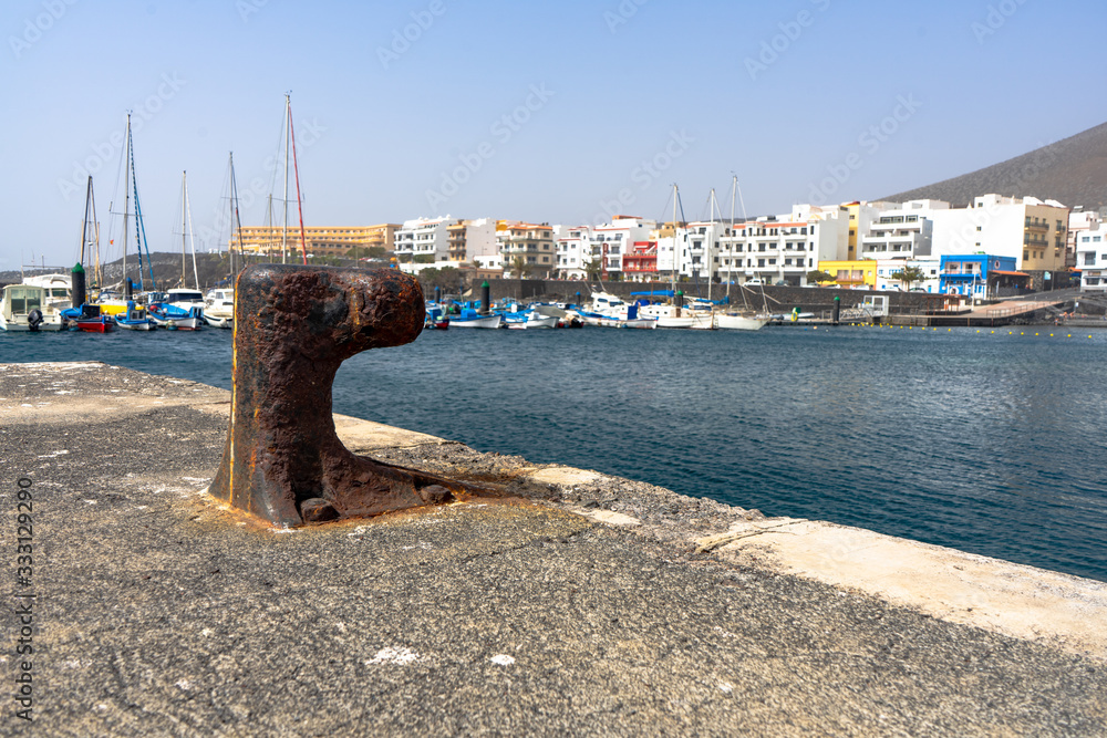 Puerto de La Restinga, on the island of El Hierro. Rusty boat mooring. Fishing boats. Puerto de La Restinga, on the island of El Hierro. Rusty boat mooring. Fishing boats.