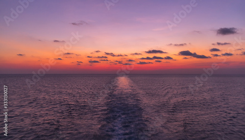 Open sea travel by ferry. Enjoying impressive vivid sunset from a boat while on boat in Indonesian waters, Java sea near near Sulawesi and Kalimantan. Exploring the sea © Edgaras