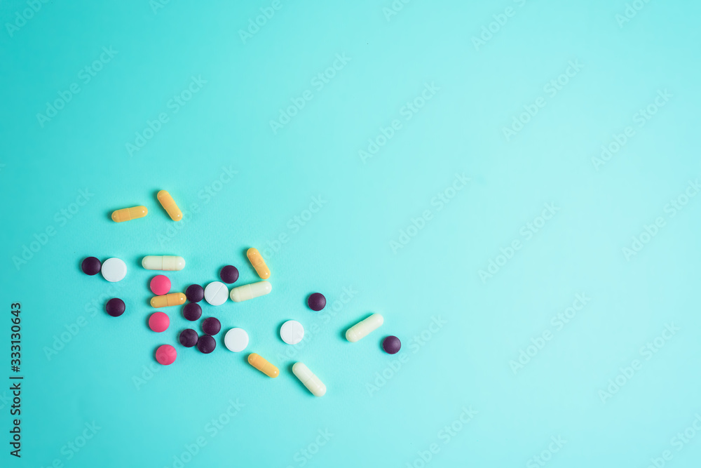 pills coronavirus from the top view. background image. capsules and tablets on a blue background. treatment of infection during a pandemic. The concept, pandemics, coronaviruses, layout. pills coronavirus from the top view. background image. capsules and tablets on a blue background. treatment of infection during a pandemic. The concept, pandemics, coronaviruses, layout.