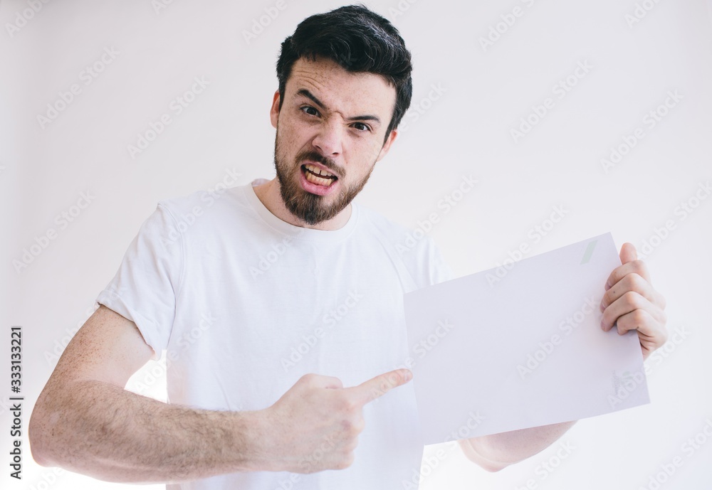 Bearded man holding a blank white sheet of paper Bearded man holding a blank white sheet of paper