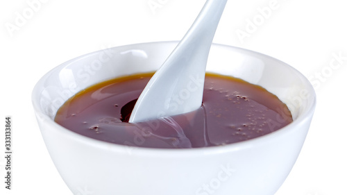 honey in ceramic bowl isolated on white background