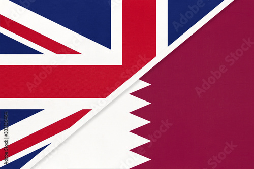 United Kingdom vs Qatar national flag from textile. Relationship between two european and asian countries.