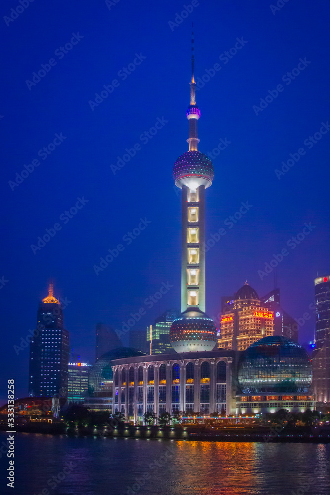 Shanghai, China - July 4, 2011 : Business center of Shanghai as seen from the river at night (vertical)
