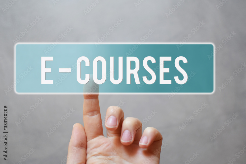 E-courses - finger pressing blue transparent button on virtual touchscreen interface on gray background with copy space for text. E-school and online education concept. E-courses - finger pressing blue transparent button on virtual touchscreen interface on gray background with copy space for text. E-school and online education concept.