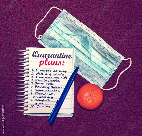 Obraz na płótnie An abstract image of a medical mask and a notebook with plans for what to do while a coronavirus quarantin w salonie
