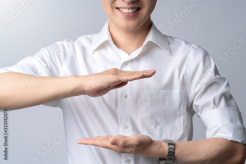 attractive asian male hand gesture present show copy space for your ideas,happiness smile posotive asian male hand point control space in the air white background photo