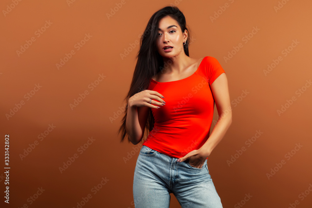 Obraz premium young pretty asian woman cheerful smiling posing on warm brown background, lifestyle people concept
