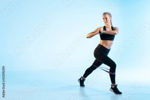 Copy space woman exercising with elastic band