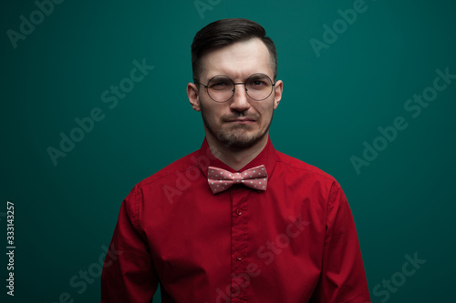 Portrait of an upset young man with glasses