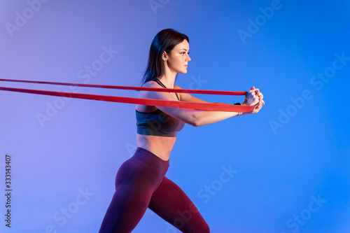 Side view woman training with elastic band