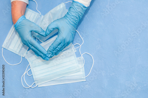 Protective medical white face mask on a blue background. View from above. Virus Prevention Space for text. Close up, gorizontal orientation